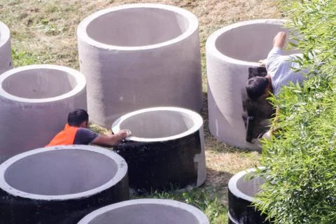 Workers put a layer of waterproofing. Stock Photos