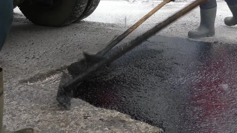Workers put liquid asphalt in the pit Stock Footage 144479218