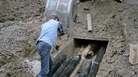 Workers put pipes with a construction crane into the ground Stock Footage 101234026