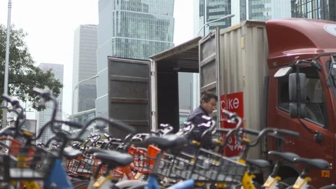 Workers put Shared bikes on the street 스톡 동영상 125471689
