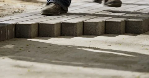 Workers put tiles in new pavement pedestrian way -- close-up Stock Footage 89909686