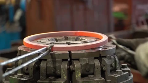 Workers put the workpiece on a Metal press to stretch the hot metal and fit  Video stock 143312509