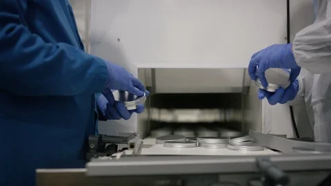Workers putting lid on cosmetic boxes in factory Stock Footage 107994884