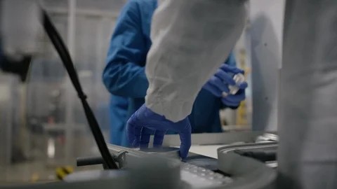 Workers putting lid on cosmetic boxes in factory Stock Footage 107994967