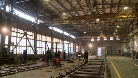 Workers raise and move large metal detail Stock Footage 84002568