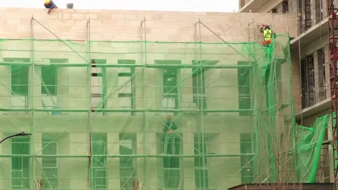 Workers reconstruct the facade of the building on scaffolding. Stock Footage 236910548