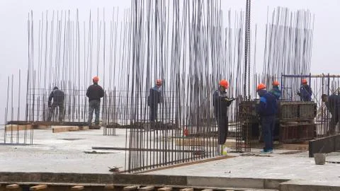 Workers in red helmets on the construction Stock Photos