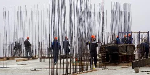 Workers in red helmets on the construction Stock Photos