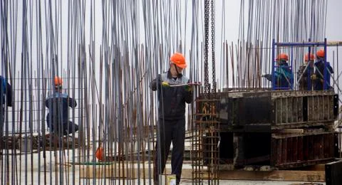 Workers in red helmets on the construction Stock Photos