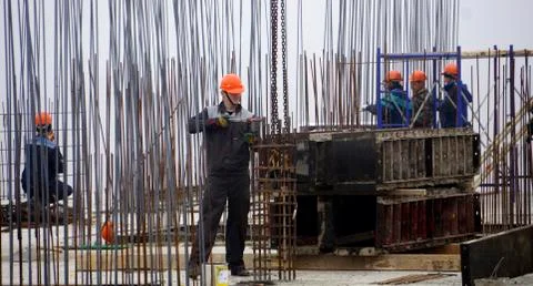 Workers in red helmets on the construction Stock Photos
