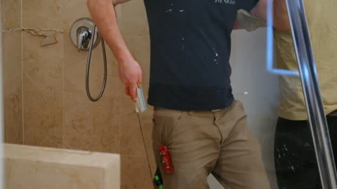 Workers remove a glass shower door bathroom renovation. Construction process Stock Footage 332185697