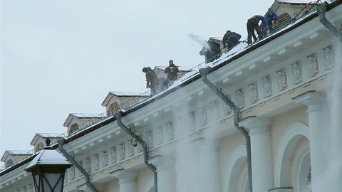 Workers remove snow from a roof. Stock Footage 70805635