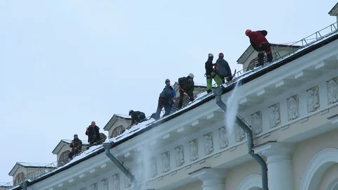 Workers remove snow from a roof. Stock Footage 70806570