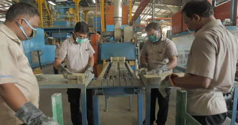 Workers Removing Battery Separators from Industrial Conveyor Belt (4K) Stock Footage 60784287