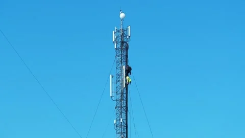 Workers repair cell tower. Laying new cables. High-altitude works Stock Footage 312071720