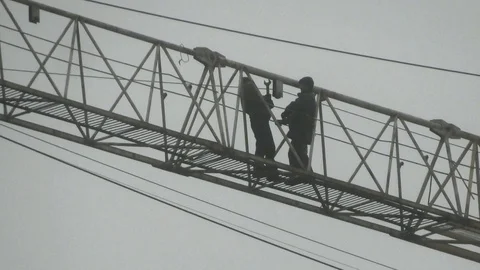 Workers repair the construction tower crane Stock Footage 87891495