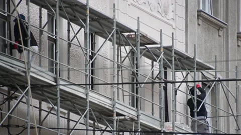 Workers repairing facade of the building at height Stock Footage 170840643