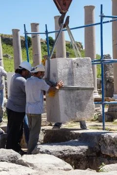 Workers restore ancient column Stock Photos