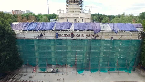 Workers restore the building in the park zone aerial view. A lot of people are Stock Footage 93589332