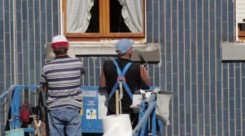 Workers restoring building facade - Caulking sills Stock Footage 49385978