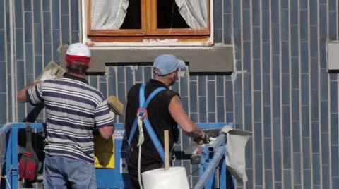 Workers restructure facade - clean smudges stucco Stock Footage 49448814