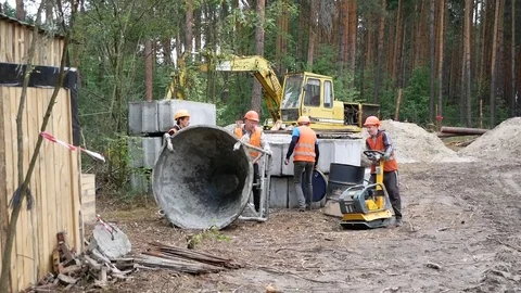 Workers roll a container for pouring concrete Stock Footage 77679195