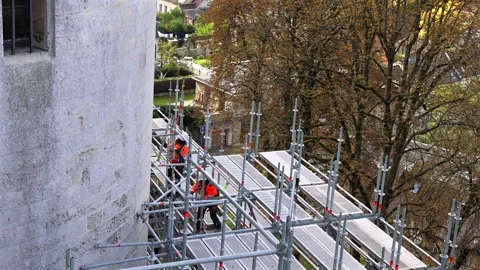 Workers on scaffolding castle outer stone wall Château de Pierrefonds. Video stock 310918541