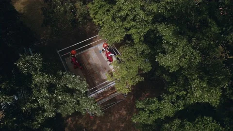 Workers on scaffolding give five with their hands Stock Footage 199323950