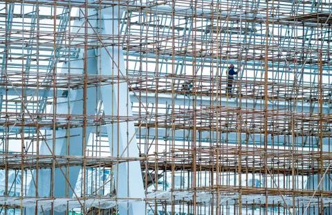 Workers on scaffolding work Stock Photos