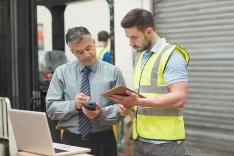 Workers scanning package in warehouse Stock Illustration