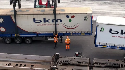 Workers Securing bkm Logistics Trailer for Rail Loading Stock Footage 338371672