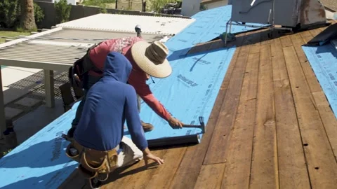 Workers Securing Plastic Sheeting on House Roof Stock Footage 329402306