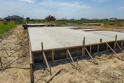Workers set up a solid foundation for a building in a quiet countryside loc.. Stock Photos