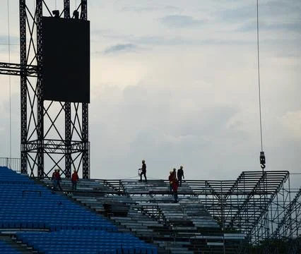 Workers setting up grandstand seating. Stock Photos