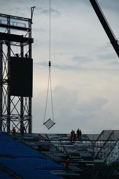 Workers setting up grandstand seating. Stock Photos