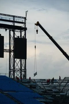 Workers setting up grandstand seating. Stock Photos