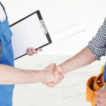Workers shaking hands Stock Photos