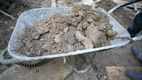 Workers shovel the ground into wheelbarrow Stock Footage 158973495