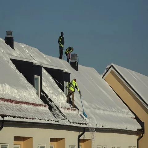 Workers shoveling snow from roofs Stock Footage 69485461