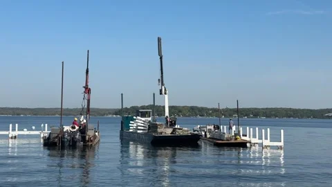Workers Skillfully Removing Lake Geneva Docks on a Tranquil Day Stock Footage 319251964
