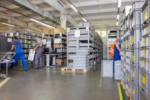 Workers in small warehouse with a variety of boxes Stock Photos