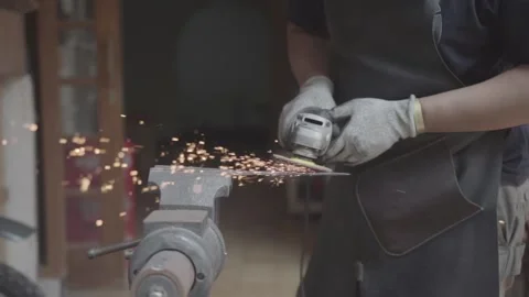Workers smoothing the iron surface of the sword Stock Footage 197378076