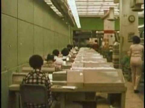 Workers sort mail in a mailroom with machines and by hand in 1976. Stock Footage 75284883