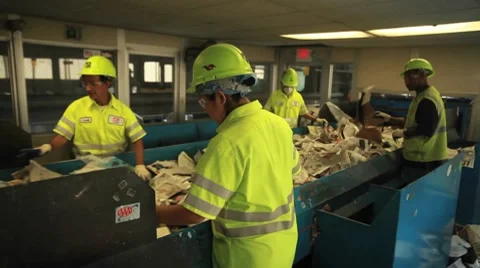 Workers sort trash at a recycling center. Stock Footage