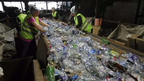Workers sorted plastic on the conveyor at the plant for processing of plastic Stock Footage 112705147