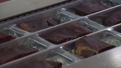 Workers sorting and packing dry meat in the food factory. Packaging of dry meat  Video stock 85709516