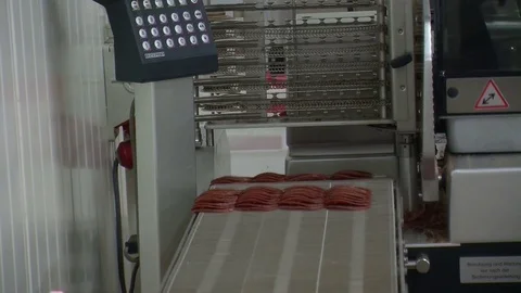 Workers sorting and packing dry meat in the food factory. Packaging of dry meat  Video stock 85709598