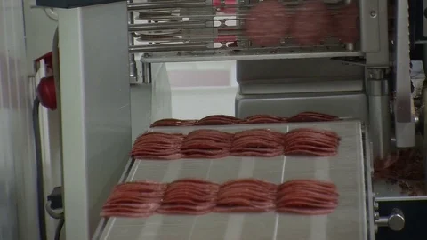 Workers sorting and packing dry meat in the food factory. Packaging of dry meat  Video stock 85709734