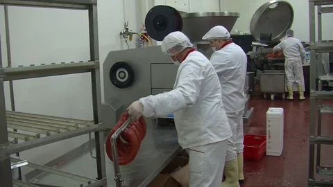 Workers sorting and packing dry meat in the food factory. Packaging of dry meat  Stock Footage 85710894