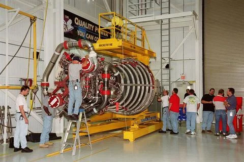 Workers in the Space Shuttle Main Engine Processing Facility prepare a new... Stock Photos